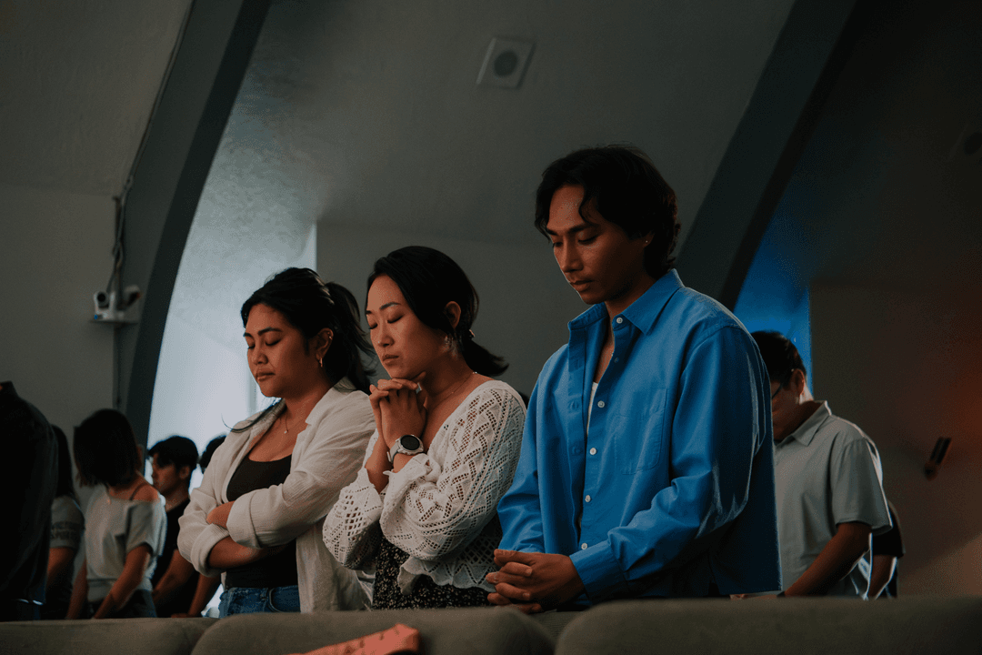 Community standing together in prayer