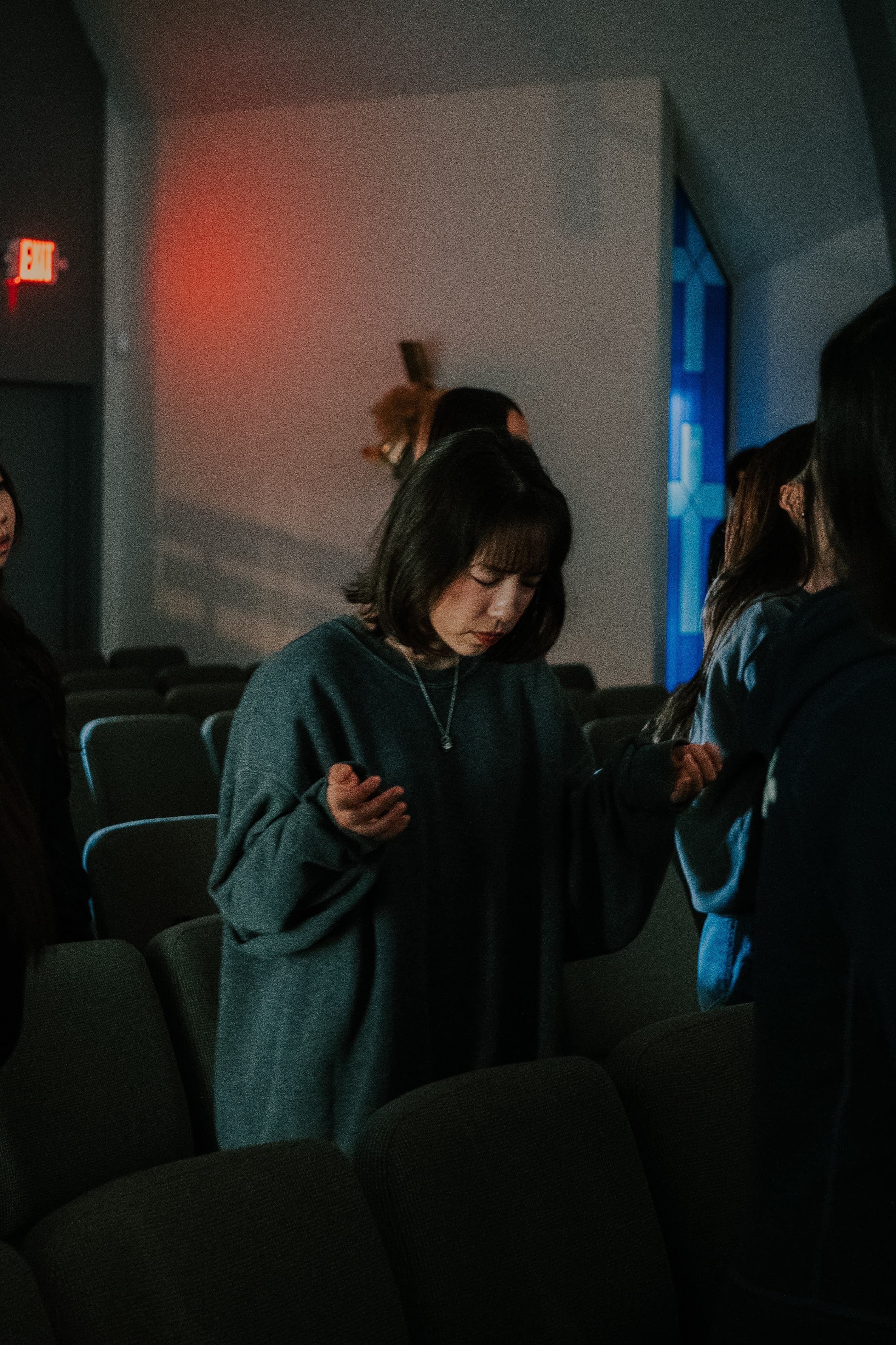 Woman in prayer at 1128 Church